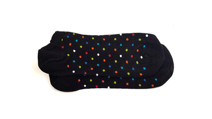 Top view of a pair of black ankle-length socks featuring vibrant, multicolored polka dots, neatly arranged and isolated on a white background.