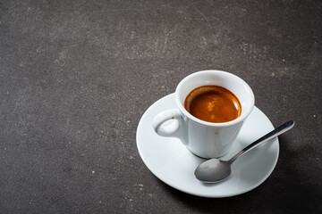 Rich Espresso Served in a White Cup on a Dark Countertop Showcasing the Artistry of Coffee Brewing in a Cozy Cafe Atmosphere
