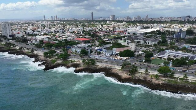 Santo Domingo, Dominican Republic, hovering near Park Centro de Los Heroes (Gazcue), panning right across Santo Domingo town with skyscraper skyline in background,  4k aerial video footage