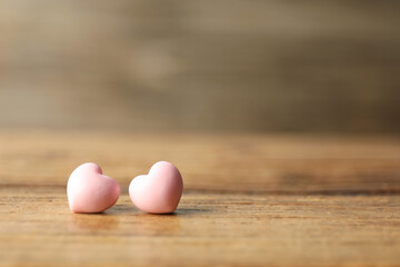 Valentine's Day. Decorative hearts on wooden table, closeup. Space for text