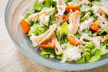 Freshly Prepared Salad Featuring Crisp Greens, Juicy Tomatoes, Creamy Cheese, and Tender Seafood for a Flavorful Dining Experience