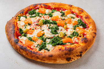 Deliciously Crafted Vegetable Pizza Topped With Kale, Feta Cheese, and Fresh Tomatoes, Showcasing Artisanal Crust and Vibrant Colors on a Rustic Concrete Surface