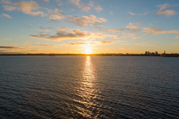 Obraz premium Tallinn Awakens: Aerial cityscape panorama of Tallinn, Estonia, bathed in the warm glow of sunrise over the bay.