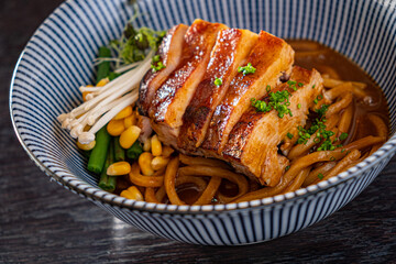 Savory Bowl of Noodles Topped With Juicy Grilled Pork and Fresh Vegetables Enjoyed in a Cozy Eatery at Lunchtime