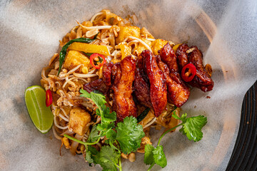 Delicious Stir-Fried Noodles With Succulent Chicken and Vibrant Vegetables Served in a Rustic Bowl