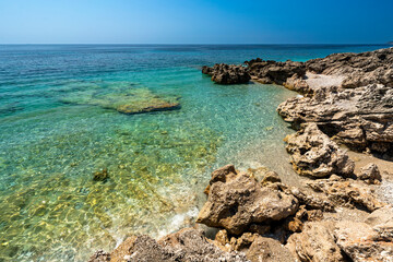 Albania, Vlorë County, Dhërmi - 14 August 2024 - Glimpse of the turquoise sea of ​​Dhërmi with picturesque rocks