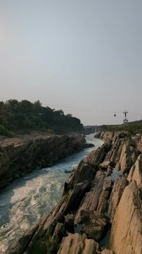 Breathtaking Scenery of River: Crystal Clear Flowing Waters, Ropeway Ride Above, and Birds Soaring in the Sky