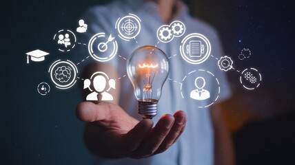 Illuminating Ideas: A Hand Holding a Glowing Light Bulb Symbolizing Innovation, Collaboration, and Strategic Thinking in Business and Education