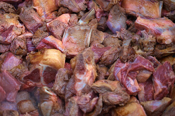 Meat is chopped into pieces. Beef for food. Texture. Preparation. Close view. No people.