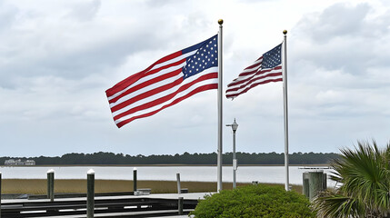 American flags waving by waterfront pier under cloudy sky. Patriotism theme image