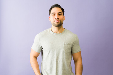 Obraz premium Confident male model posing on purple background