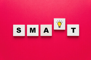 Smart word with ligh bulb icon on red background, smart goal setting, think smart concept