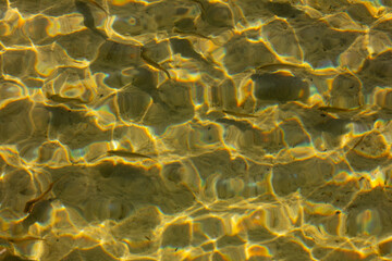 Golden Reflections on a Crystal Clear Water Surface, Capturing the Essence of Natures Beauty