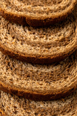Obraz premium Slice ​​piece dark light bread dough twisted spiral white background coarse grinding