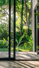 Naklejka premium Sleek Sliding Glass Door to Lush Backyard - Energy Efficient Design for Modern Homes