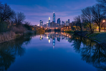Fototapeta premium City skyline reflecting on calm water during vibrant twilight with colorful hues and bright city lights creating a serene urban landscape