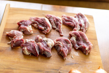 Pieces of raw meat on a wooden board. Food concept
