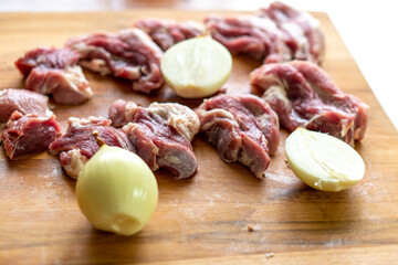 Pieces of raw meat on a wooden board. Food concept