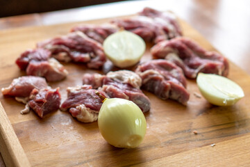 Pieces of raw meat on a wooden board. Food concept