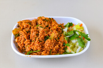 Traditional turkish bulgur pilaf with tomato sause in plate (Turkish name; bulgur pilavi, meyhane pilavi) Pirinc pilavi. Pilavustu tavuk, nohut, kuru fasulye, ciger.