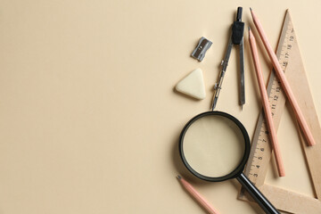 Flat lay composition with ruler and other stationery on beige background, space for text