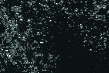 Many water bubbles on black background, closeup
