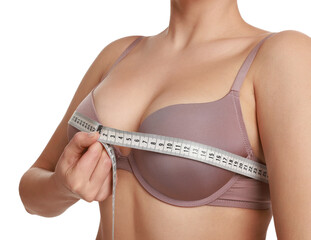 Woman in beautiful bra measuring breast circumference on white background, closeup
