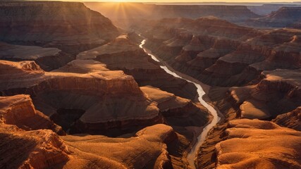 Grand Canyon river view at sunset with rocky cliffs and clear sky, perfect for travel backgrounds.