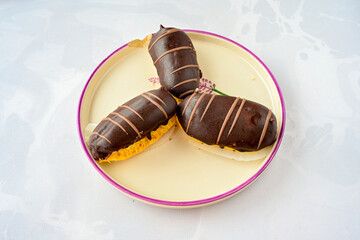 Ekler Pasta Turkish delicious ekler pasta with plate. Klasik, cikolatali, muzlu, frambuazli, karamelli, cilekli, oreolu ekler.