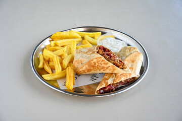 Lavash zurna doner kebab ( zurna  durum )  or shawarma sliced in plate isolated.  hatay usulu tavuk Et doner durum. Gobit ekmek arasi doner. Pilavustu iskender doner kebap. 
