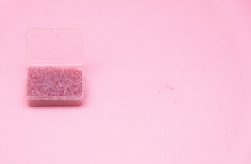 Silica gel or desiccant in box isolated on pink background.