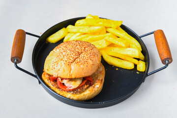 Big tasty burger with beef cutlet on a plate. Hamburger, cheeseburger with mushroom. Hamburger, Mexica, mushroom double burger.  Crispy chicken burger. With french fries, patates kizartmasi.