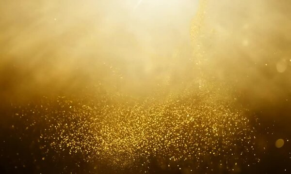 Abstract footage of golden glitter particles floating in the air, illuminated by a bright light source. The particles create a shimmering, magical effect, reminiscent of fairy dust or a cele