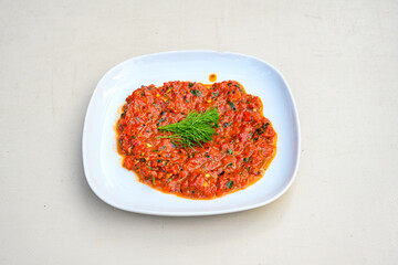 Grilled eggplant paste appetizer on white background .Healthy food. Turkish name koz patlican ezmesi. Koz patlican, koz kirmizi biber kapya salatasi.