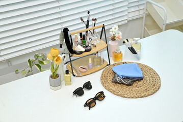 Various cosmetics and objects on a vanity table for a woman to do her makeup	
