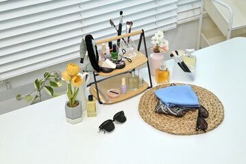 Various cosmetics and objects on a vanity table for a woman to do her makeup	

