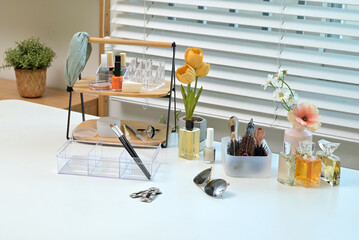 Various cosmetics and objects on a vanity table for a woman to do her makeup	
