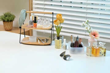 Various cosmetics and objects on a vanity table for a woman to do her makeup	
