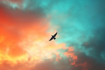 Fototapeta premium Majestic Bird Soaring Through a Colorful Sky at Dusk with Vibrant Clouds and Warm Hues