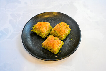 Turkish Dessert Sobiyet, havuc dilimi, midye baklava, mussels baklava and classic baklava with Pistachio . Cikoltali cevizli, fistikli soguk Baklava, top view.