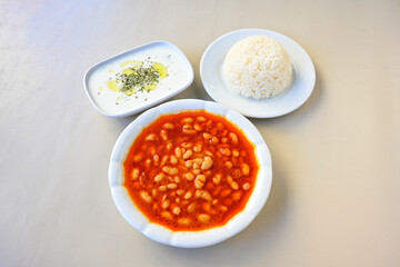 Turkish Etli Kuru Fasulye food with Traditional Turkish table with decoration. Nohut yemegi. Pilav ustu, kuru fasulye, nohut. Gunun menusu.
