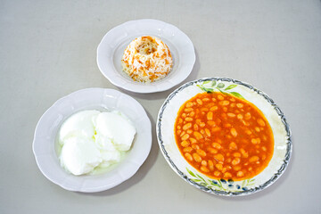 Turkish Etli Kuru Fasulye food with Traditional Turkish table with decoration. Nohut yemegi. Pilav ustu, kuru fasulye, nohut. Gunun menusu.