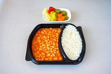 Turkish Etli Kuru Fasulye food with Traditional Turkish table with decoration. Nohut yemegi. Pilav ustu, kuru fasulye, nohut. Gunun menusu.