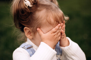 Little girl hiding her face