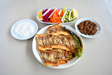 Kiymali pide.Turkish pide with minced meat. Turkish pizza mince pita Pide on white . Etli ekmek.Kusbasi kasarli, kiymali kasarli, kiymali yumurtali, Bafra, Trabzon, Kusbasili pide. Urfa acili lahmacun