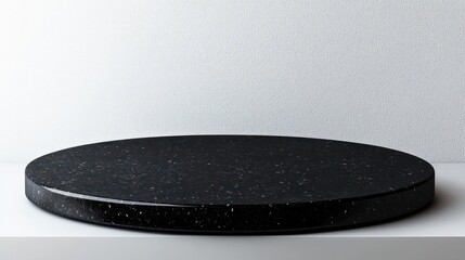 Elegant Black Round Display Platform Against Textured Background