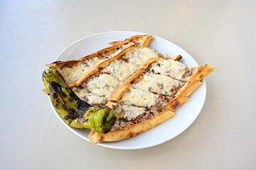 Kiymali pide.Turkish pide with minced meat. Turkish pizza mince pita Pide on white . Etli ekmek.Kusbasi kasarli, kiymali kasarli, kiymali yumurtali, Bafra, Trabzon, Kusbasili pide. Urfa acili lahmacun