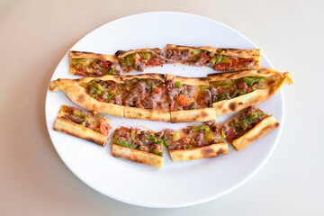 Kiymali pide.Turkish pide with minced meat. Turkish pizza mince pita Pide on white . Etli ekmek.Kusbasi kasarli, kiymali kasarli, kiymali yumurtali, Bafra, Trabzon, Kusbasili pide. Urfa acili lahmacun