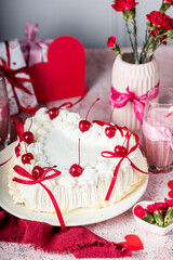 heart-shaped tiramisu cake with white cream, coffee glaze, cocktail cherry, red decorative ribbons, Valentine's Day cake, red flowers in a vase, tiramisu with cherry, mousse cake