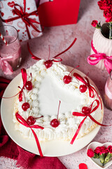 heart-shaped tiramisu cake with white cream, coffee glaze, cocktail cherry, red decorative ribbons, Valentine's Day cake, red flowers in a vase, tiramisu with cherry, mousse cake